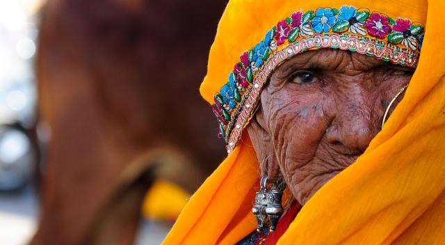 A woman peeking out under a scarf