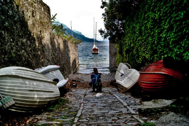 View of boat on lake down a narrow street