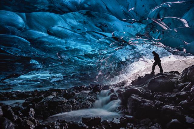 man in waterfall cave