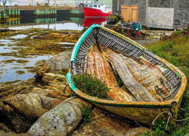 Colorful shell of a boat on shore