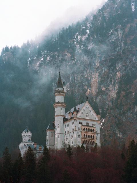 Exterior image of Neuschwanstein Castle with clouds.