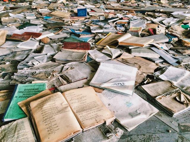 Books in bad condition laying on floor