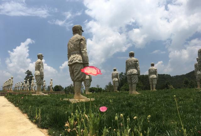 statues of soldiers in field 