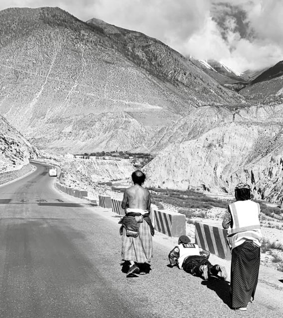 3 people standing on road