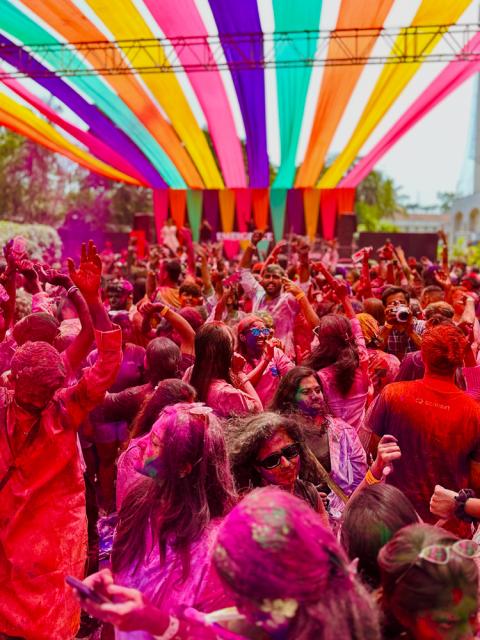 Large group of people dancing at festival.