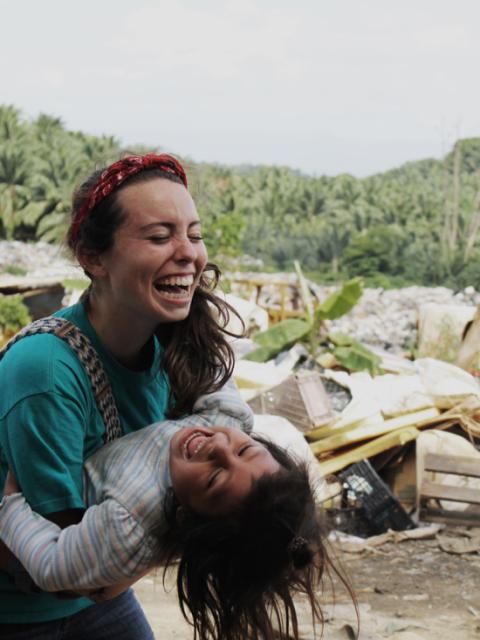 woman laughing holding child