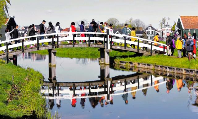 people walking across bridge