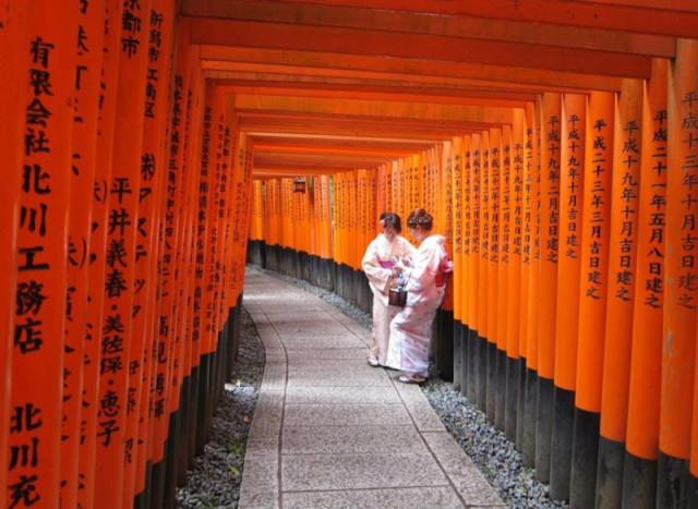 two women standing in pathway 