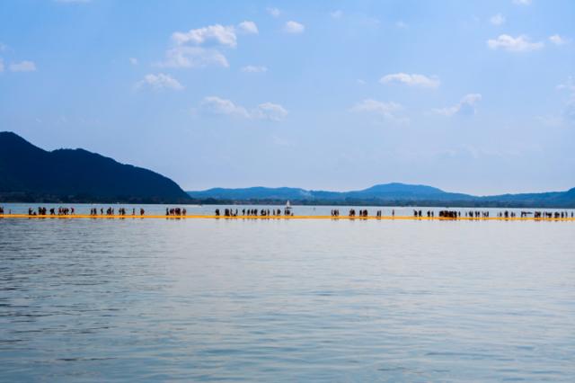 people walking across path on water