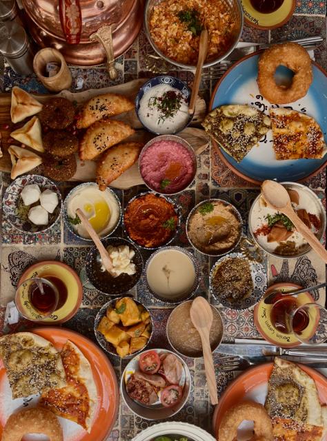 Many bowls of food on a table.