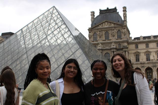 Four young women in front of the Louvre pyramid