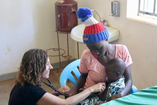 Pediatrician checks the heartbeat of a child in a rural hospital