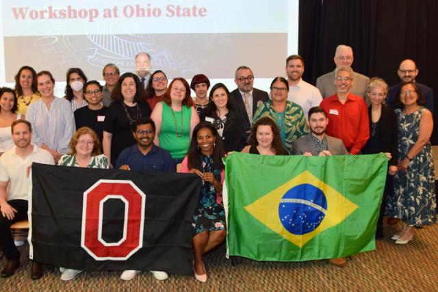 Group of professionals holding an Ohio State flag and a Brazil flag