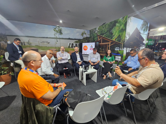 Professors, students, and alumni are seated forming a circle at a COP30 event