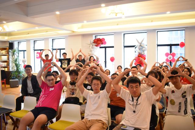 Students doing O pose in audience