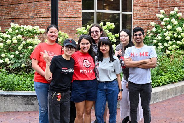 Group of Global Engagement Leaders outside of a brick building