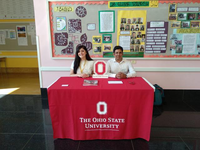 Two People sitting behind an Ohio State Desk