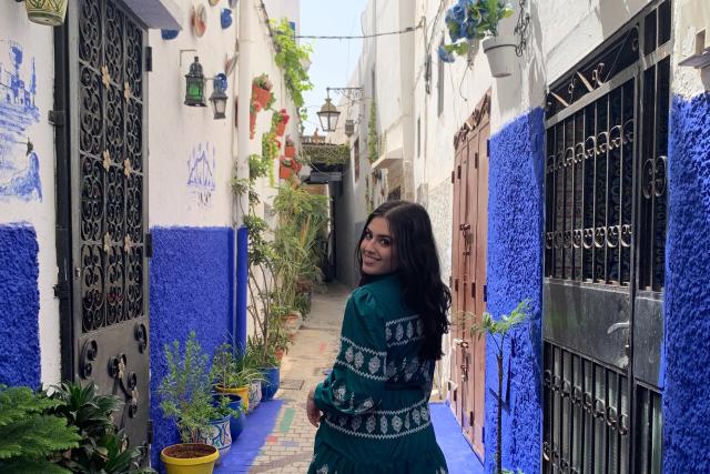 Young woman poses in Moroccan alley