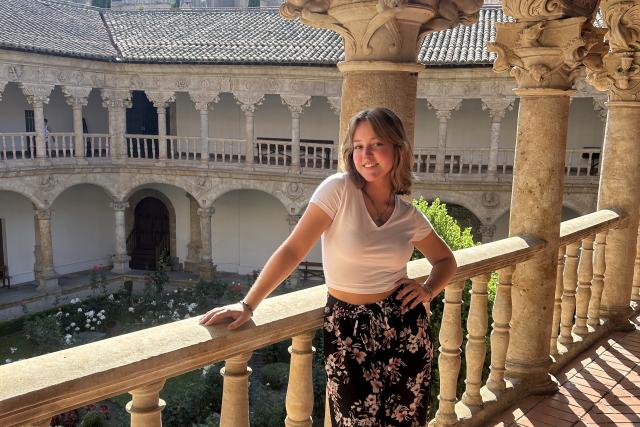 Young woman posing in front of a Spanish banister