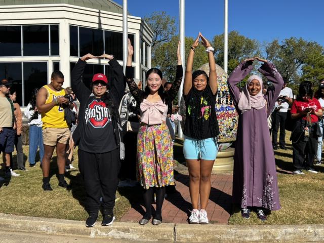 O-H-I-O outside with four students