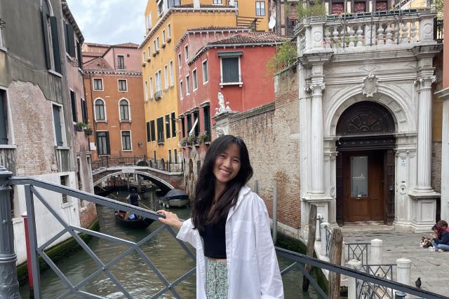 Young woman in front of Italian canal