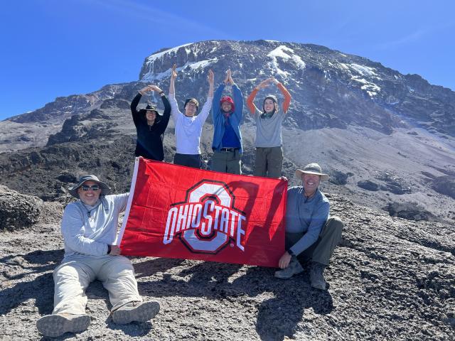 A group of Buckeyes pose on a mountaintop