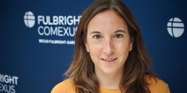 Headshot of Margaret Kwoka in front of Fulbright backdrop