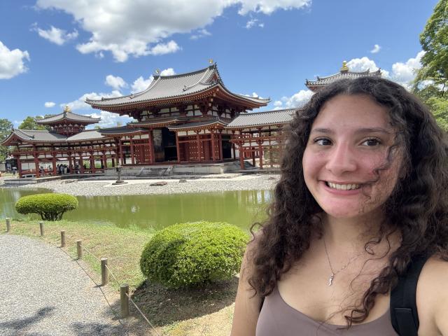 student in Japan with temple in the background