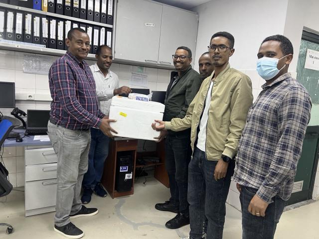 Six scientists in Ethiopia deliver reagents for use in laboratory testing to determine spread of disease.