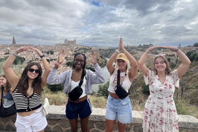 Group of four students in Spain doing an O-H-I-O