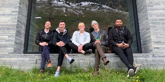 people posing on a building stoop