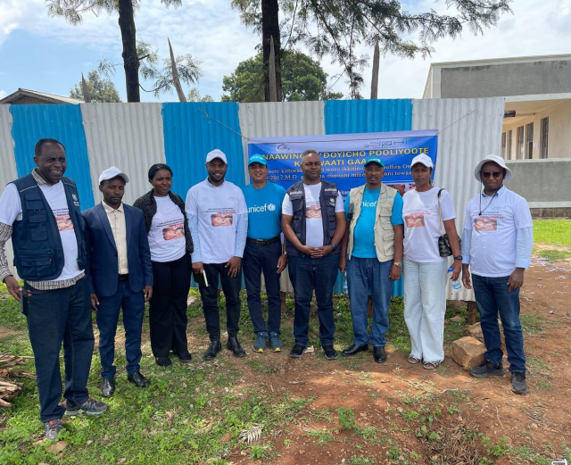 Men standing in front of wall in Ethiopia.