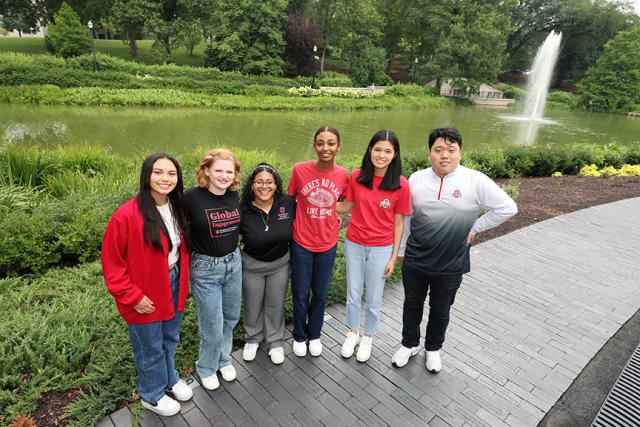 Group of people in Ohio State regalia in front of Mirror Lake