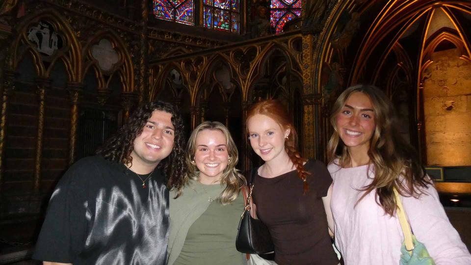 Students posing in a dark church