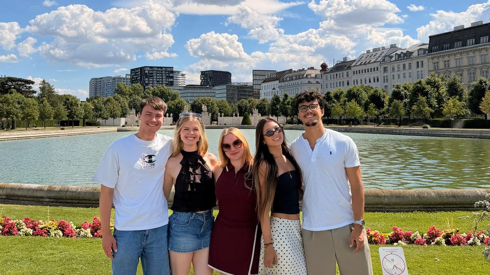Students overlooking body of water
