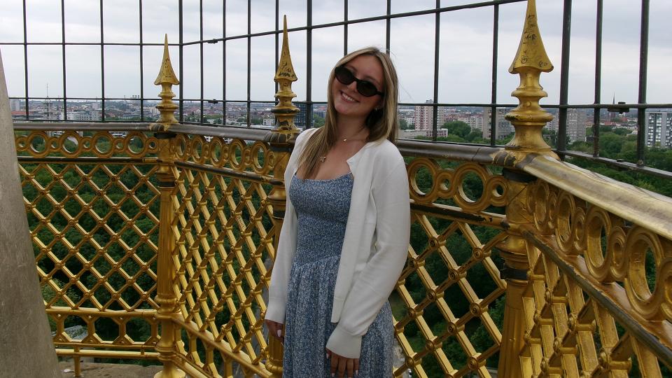 Student posing atop a building