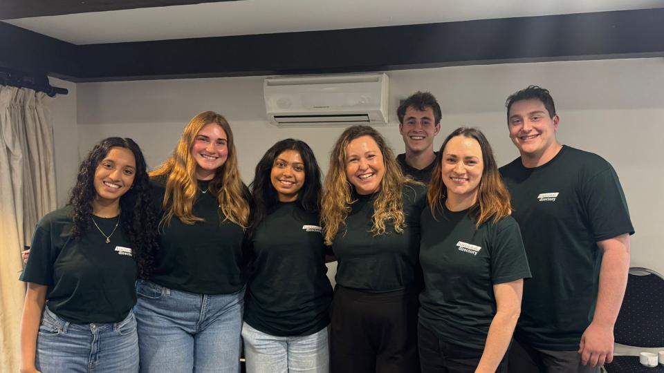 Students in matching shirts in an office