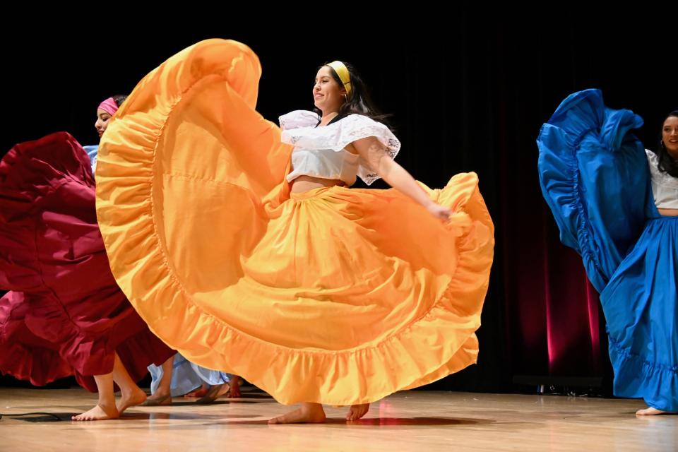Dancers on stage at Taste of OSU in colorful costumes