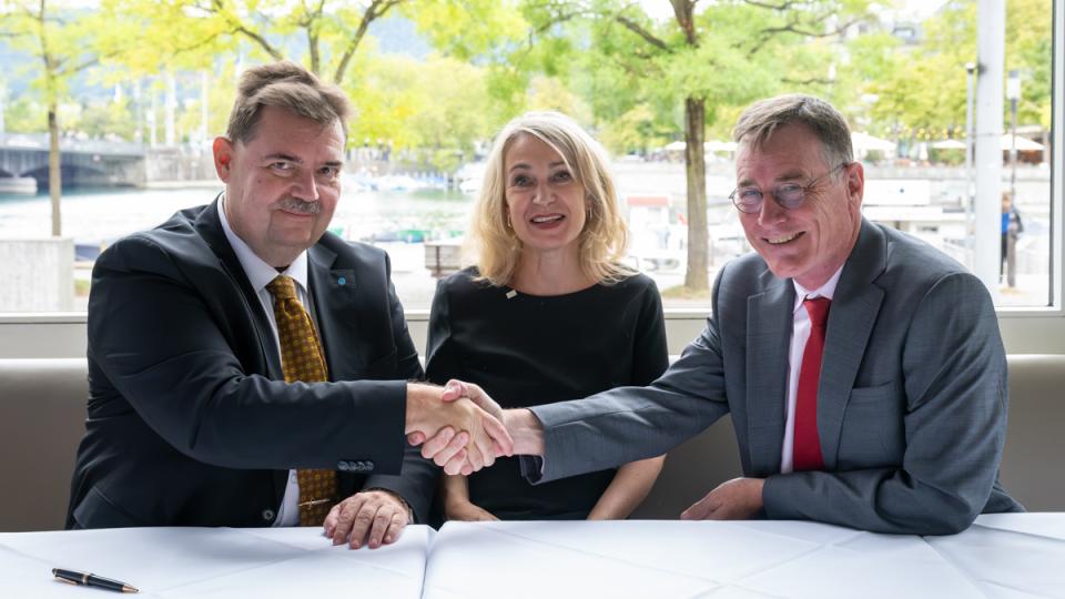 Two men in business suits shake hands