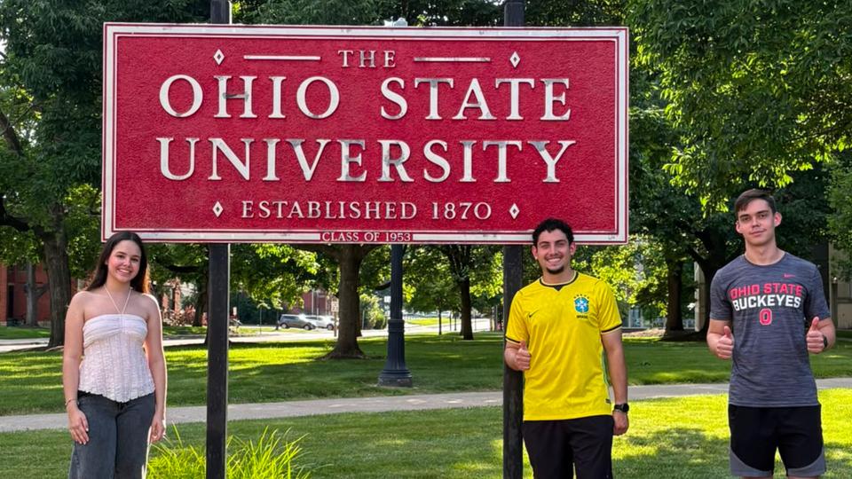 Students standing near Ohio State sign