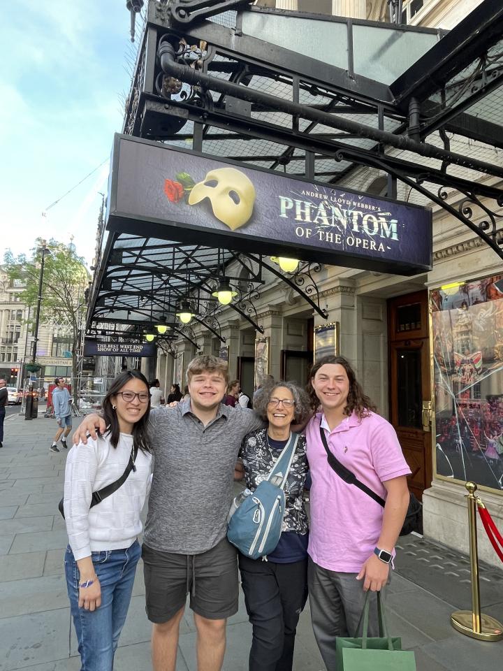 Four students in London in front of a theatre