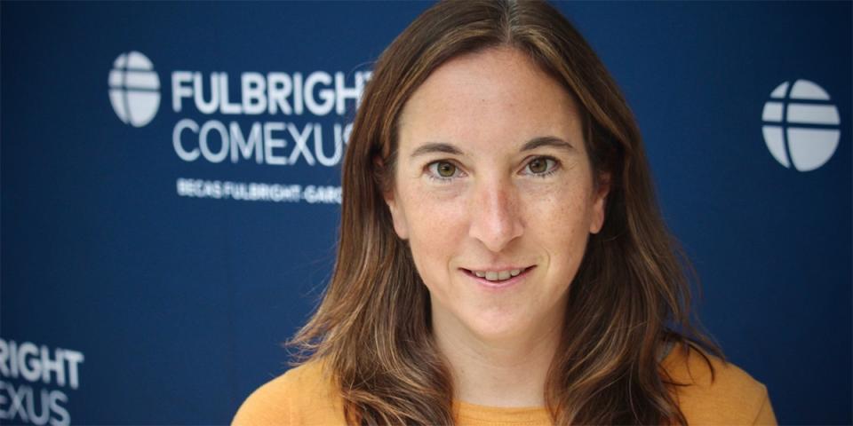 Headshot of Margaret Kwoka in front of Fulbright backdrop