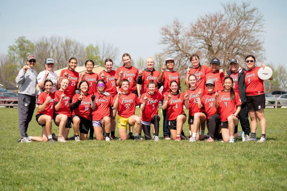People in matching uniforms smiling