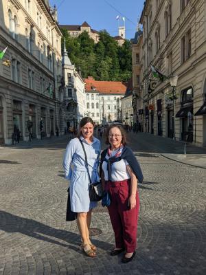 Two woman posing in European street