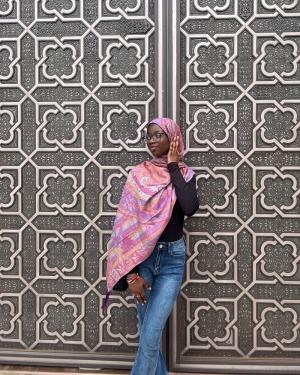 Woman stands by middle eastern door