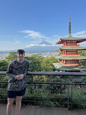 student with tower in the background