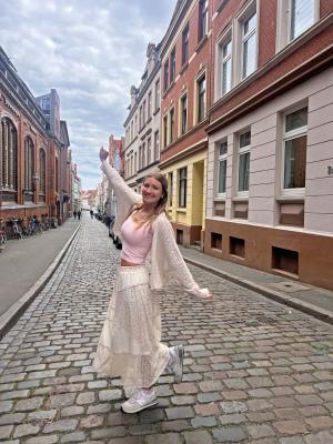 student posing in an alley