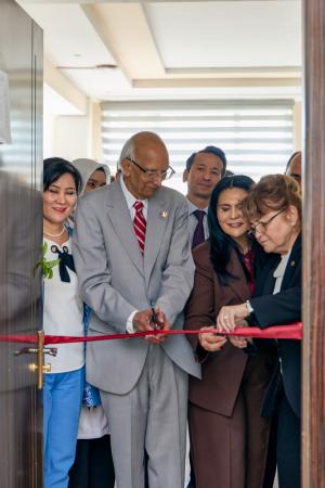 Group of individuals participating in a ribbon-cutting ceremony.