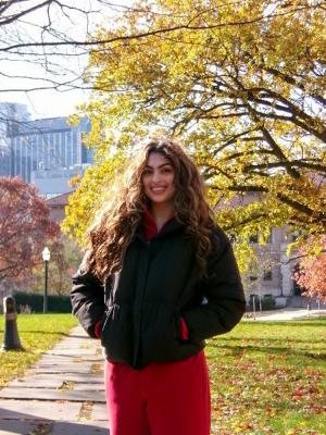 Woman wearing black jacket with fall colors in background