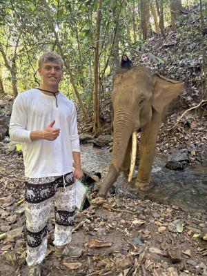 student with elephant
